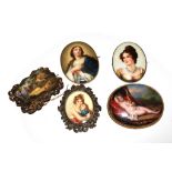 A collection of five porcelain plaques, all mounted as brooches