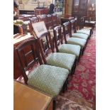 A set of six Edwardian stained beech dining chairs, the H-form backs over stuffover seats and turned