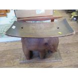 An African hardwood stool carved as an elephant, 51cm wide, 47cm high