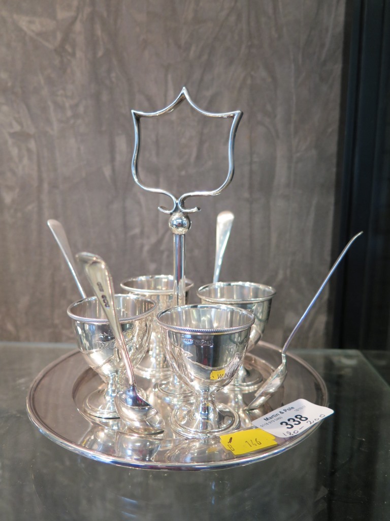 A silver egg cup stand with four silver egg cups and spoons, Sheffield 1918, 537 grams
