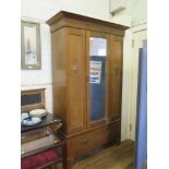 An Edwardian two piece bedroom suite, the wardrobe with mirrored door over a long drawer, 123cm wide