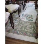 A large European style ivory field carpet with green foliate scroll and floral medallion and border,