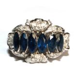 A diamond and six stone marquise blue stone ring (possibly sapphires) set in white metal