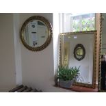 A rectangular giltwood mirror with bevelled plate 72cm x 50cm and an oval mirror 61cm x 51cm