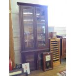 An Edwardian stained pine glazed bookcase with two pairs of doors, from a larger bookcase 103cm wide