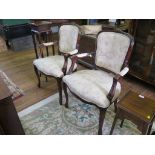 A pair of Louis XVI style open armchairs, with upholstered backs, seats and padded arms on floral