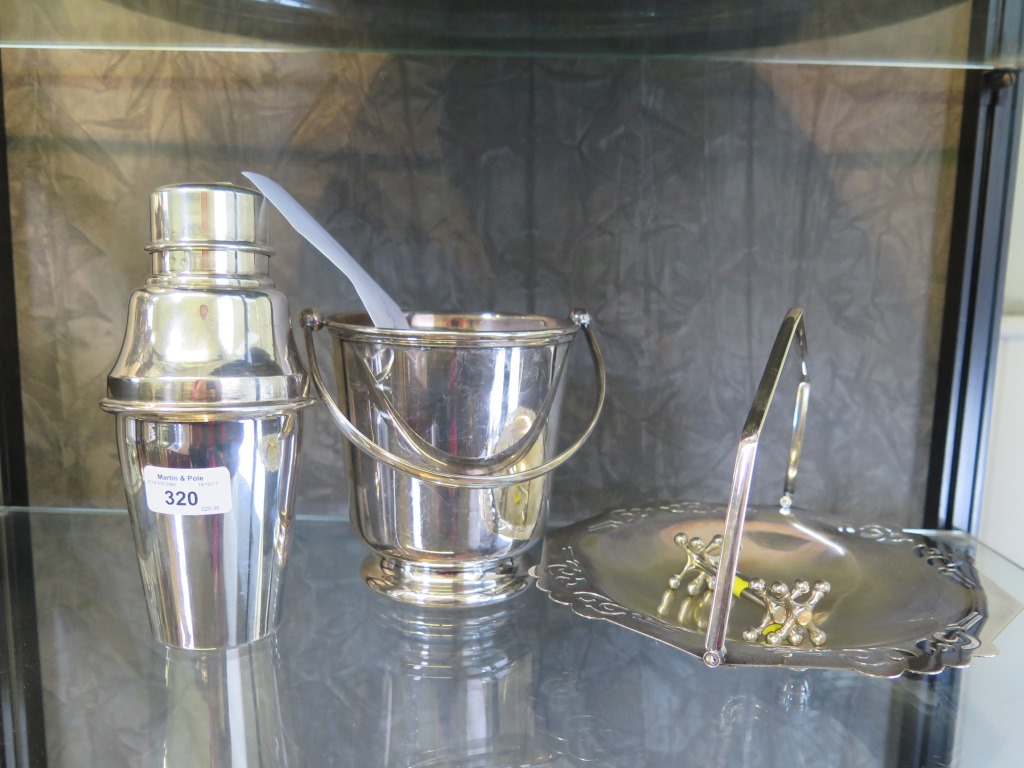 A cocktail shaker, an ice bucket, a swing handle basket, a pair of knife rests