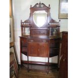 An Edwardian walnut mirror-back side cabinet, the shield shape mirror over mirror-back shelves,