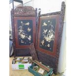 A Japanese two fold screen, the lacquer Shibayama style panels inset in mother of pearl to depict