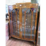 A walnut bowfront display cabinet, with lancet arched doors and cabriole legs, 88cm wide, 124cm