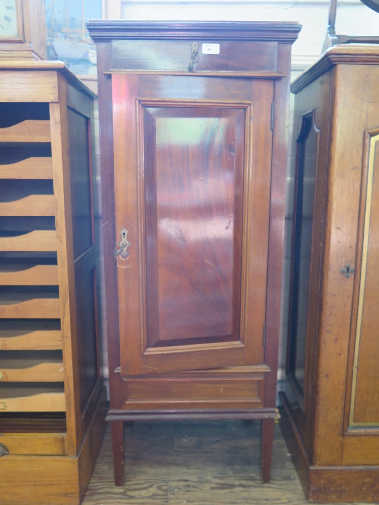 An early 20th century mahogany cased humidor cabinet, with frieze drawer over a cupboard door fitted