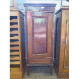 An early 20th century mahogany cased humidor cabinet, with frieze drawer over a cupboard door fitted