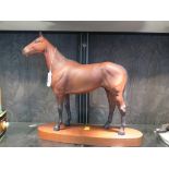 A Beswick Model of Arkle Champion Steeplechaser, on a wooden base (repair to ear) 30cm high