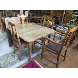An oak extending dining table on square tapering legs 99cm wide, and a set of four oak dining