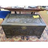 A Chinese stained and carved camphor wood chest, of rectangular form depicting court scenes, on