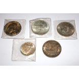 A collection of five U.S.A. silver dollars
