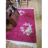 A Chinese floral rug with crimson field 205cm x 93cm