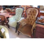 A pair of Victorian mahogany button back armchairs with cabriole legs and castors