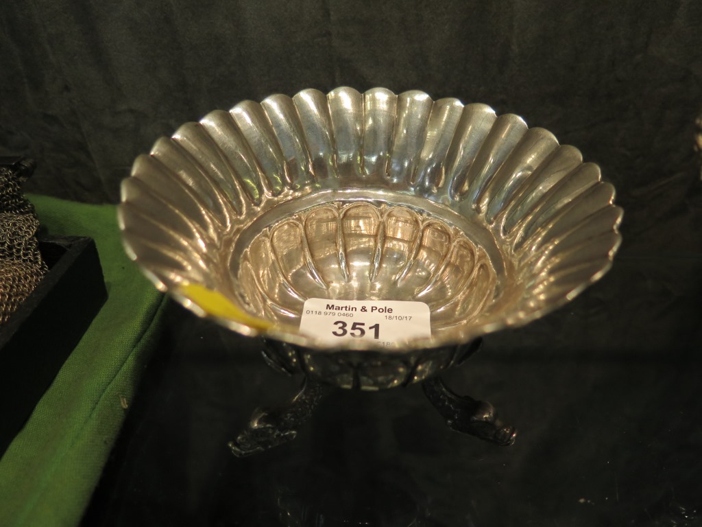 A Chinese export silver dish or bowl with three dolphin head feet, 12cm diameter