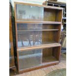 A Minty teak stacking bookcase, of three graduated tiers with sliding glass doors, 89cm wide,