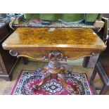 A mid Victorian burr walnut foldover card table, the circular baize interior over a floral carved
