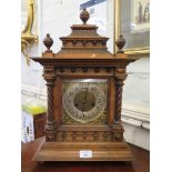 An Edwardian walnut mantel clock, the tile effect caddy top over a brass dial flanked by columns,