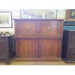 An Edwardian walnut secretaire, the partially hinged top and front revealing a sliding fitted