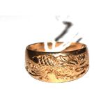 A gentleman's 9 carat gold ring with dragon decoration