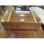 An early 19th century rosewood and brass bound writing box, with brass bands (as found) and fitted