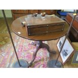 A George III style mahogany tripod table, the circular top on a birdcage hinge and baluster