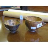 Two coconut shell cups, one with floral carving 5.5cm and 7cm high