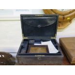 A tooled leather box, with inset handle, Bramah lock and tray interior with inkwell and pen tray,