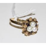 A 9 carat gold ring set with pearls and sapphires