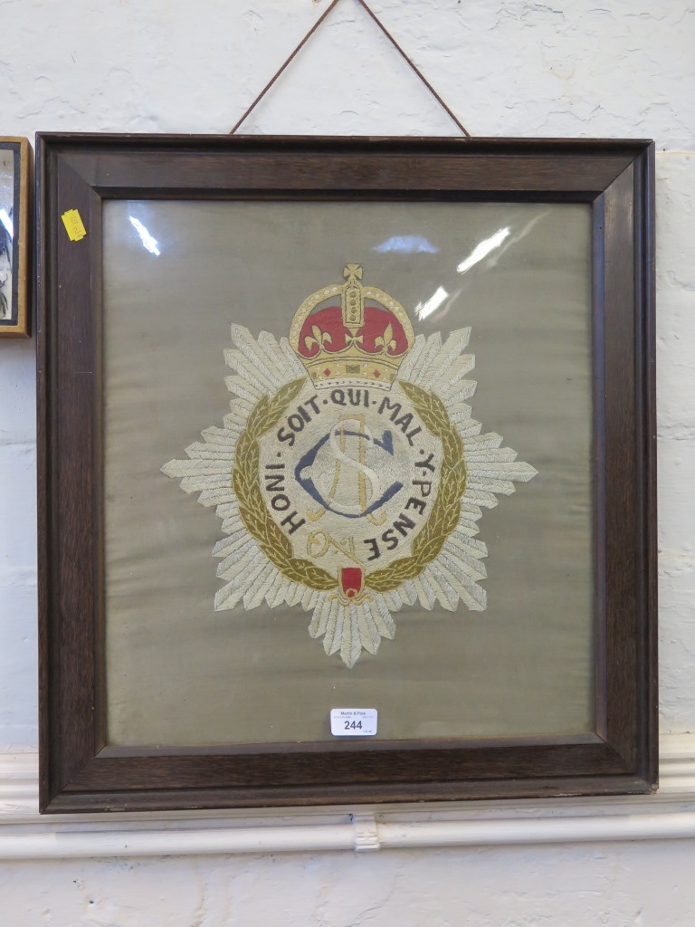 An early 20th century silk embroidered military badge for the Army Service Corps, 43cm x 40cm