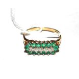 A three line emerald and diamond ring set in 9 carat gold