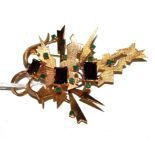 A 14 carat gold brooch, set with trap cut garnets and round emeralds