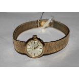 A lady's 9 carat gold Omega wristwatch with 9 carat gold integral bracelet