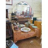 A 1930's walnut dressing table, the long triptych mirror over four drawers with Art Deco handles, on