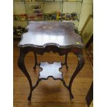 An Edwardian mahoany window table, the shaped square top on acanthus carved cabriole legs joined