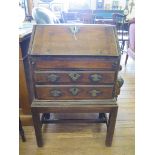 A small George III mahogany bureau, possibly an apprentice piece, the sloping fall enclosing a