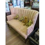 An Edwardian mahogany wing two seat settee, on square tapering legs with brass castors, 127cm wide