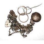 A silver locket and chain, a silver bracelet and three silver rings