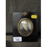 A signed miniature of an 18th century gentleman within a black frame, 7.5cm x 6cm (oval)