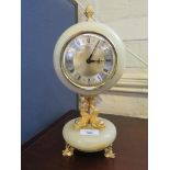 An Xavier of London Onyx table clock with dolphin supports, quartz movement 30cm high