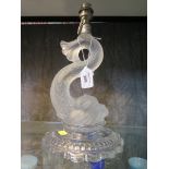 A Baccarat glass table lamp in the form of a dolphin, on a shaped circular base, 25cm high