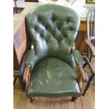 A Victorian leather upholstered armchair, the arched button back over padded scroll arms on turned