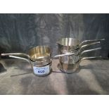 A collection of seven miniature silver plated saucepans