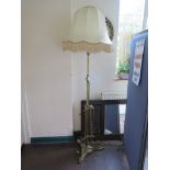 An Edwardian brass adjustable standard lamp, on a scrolling tripod base