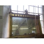 A Regency style giltwood overmantel mirror, with eagle surmount above a rectangular plate flanked by