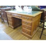 An oak pedestal desk, the leather inset top over three frieze drawers above two banks of three